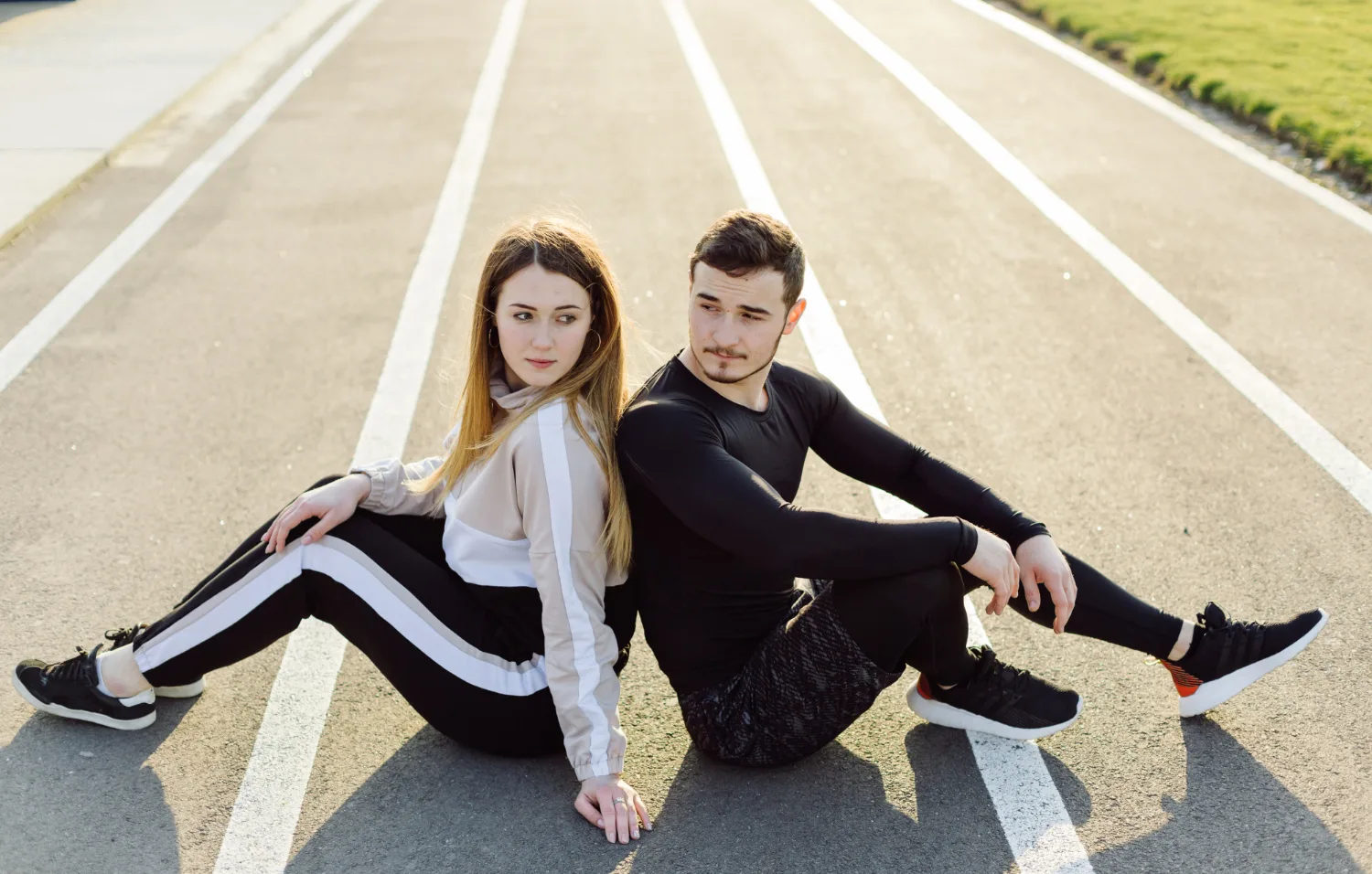 two people sitting together on road